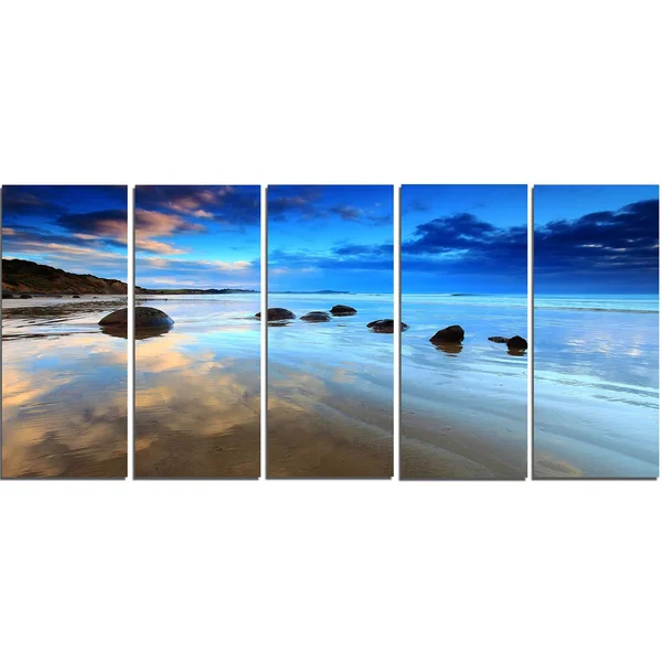 Design Art 'Cloudy Sky Over Moeraki Boulders' Photographic Print on Wrapped Canvas - Size: 16 inch H x 32 inch W x 1 inch D, Blue